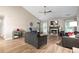Open-concept living room with high ceilings, fireplace, hardwood floors, and ample natural light at 7720 Paddocks Mill Dr, Cumming, GA 30041