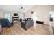 Open-plan living room with a fireplace, comfortable seating, and natural light creates a cozy space at 7720 Paddocks Mill Dr, Cumming, GA 30041