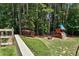 Well-maintained backyard with play structure and fenced perimeter at 1120 Bentwater Dr, Acworth, GA 30101