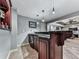 Interior bar with granite counter top, glass shelving and dark wood cabinetry at 1120 Bentwater Dr, Acworth, GA 30101
