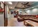 Wide shot of basement with sectional sofa, coffee table, bar and ceiling fan at 1120 Bentwater Dr, Acworth, GA 30101