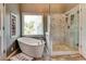 Bright bathroom featuring a soaking tub, marble-tiled shower, and modern fixtures at 1120 Bentwater Dr, Acworth, GA 30101