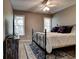 Bedroom with decorative rug, iron bed frame, and natural light from two windows at 1120 Bentwater Dr, Acworth, GA 30101