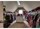 Walk-in closet with an array of clothing, carpets and a window for natural light at 1120 Bentwater Dr, Acworth, GA 30101