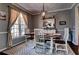Elegant dining room with modern chandelier, large window, and a rustic table at 1120 Bentwater Dr, Acworth, GA 30101