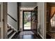 Welcoming foyer with a dark wooden door, stairs, hardwood floors and coat closet at 1120 Bentwater Dr, Acworth, GA 30101