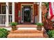 Inviting front entrance with brick steps, decorative plants, and a charming welcome sign at 1120 Bentwater Dr, Acworth, GA 30101