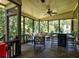 Well-decorated screened porch with ceiling fan, furniture, lighting, and wooded view at 1120 Bentwater Dr, Acworth, GA 30101