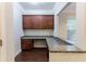 Home office featuring hardwood floors, built-in desk, and granite counters at 139 Vinca Cir, Suwanee, GA 30024