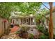 Landscaped backyard with a screened-in porch, brick pathway, and lush plantings at 2283 Pembrook Ne Pl, Atlanta, GA 30324