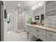 Bright bathroom features white tile, glass shower, and vanity with marble countertop at 2283 Pembrook Ne Pl, Atlanta, GA 30324