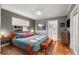 Cozy bedroom with blue accents, hardwood floors, and a comfortable bed at 2283 Pembrook Ne Pl, Atlanta, GA 30324