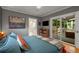 Bedroom featuring a sliding glass door to deck, TV, and shelving unit at 2283 Pembrook Ne Pl, Atlanta, GA 30324