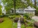 Landscaped front yard with stone walkway leading to a charming light gray home at 2283 Pembrook Ne Pl, Atlanta, GA 30324