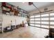 Organized garage with storage shelves and a transparent glass panel garage door at 2283 Pembrook Ne Pl, Atlanta, GA 30324