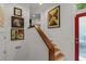 Hallway with wood stairs, bright walls adorned with art, and a red-framed glass door at 2283 Pembrook Ne Pl, Atlanta, GA 30324