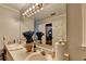 Bathroom vanity with double sinks, neutral countertops, and a large mirror at 2538 Anchors Way, Snellville, GA 30078