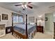Inviting bedroom with four-poster bed, ceiling fan, and matching bedside tables providing a serene retreat at 2538 Anchors Way, Snellville, GA 30078