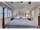Spacious bedroom showcasing a well-lit space with a four-poster bed and neutral decor for a calming ambiance at 2538 Anchors Way, Snellville, GA 30078