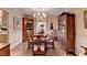 Elegant dining room featuring wainscoting, chandelier lighting, and traditional wood furniture at 2538 Anchors Way, Snellville, GA 30078