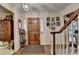 Entrance area with hardwood floors, staircase, and wood door at 2538 Anchors Way, Snellville, GA 30078