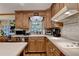 Kitchen featuring wood cabinets, a white countertop, and white tile backsplash at 2538 Anchors Way, Snellville, GA 30078