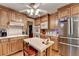 Kitchen with stainless steel appliances, wood cabinets, and tile backsplash at 2538 Anchors Way, Snellville, GA 30078