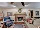 Relaxing living room with a brick fireplace, soft lighting, and comfortable furnishings at 2538 Anchors Way, Snellville, GA 30078