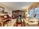 Cozy living room with a large window, bookshelves, piano, and comfortable seating at 2538 Anchors Way, Snellville, GA 30078