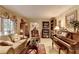 Inviting living room featuring a comfortable couch, grand piano, bookshelves, and a large window at 2538 Anchors Way, Snellville, GA 30078