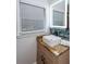 Stylish bathroom featuring a modern sink with a granite countertop, a backsplash, and a window at 3336 Forrest Hills Dr, Hapeville, GA 30354