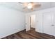 Bright bedroom with wood-look floors, a ceiling fan, and a doorway at 3336 Forrest Hills Dr, Hapeville, GA 30354