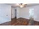 A sunlit bedroom features hardwood floors, ceiling fan, and convenient access to bathroom and closet at 3336 Forrest Hills Dr, Hapeville, GA 30354