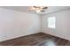 Bedroom featuring wood-look floors, a ceiling fan, a large window, and fresh white walls at 3336 Forrest Hills Dr, Hapeville, GA 30354