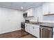 Bright kitchen featuring stainless steel appliances, granite countertops, and white cabinetry at 3336 Forrest Hills Dr, Hapeville, GA 30354