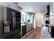 Renovated kitchen with grey cabinets, granite countertops, stainless steel appliances, and rustic hardwood flooring at 3336 Forrest Hills Dr, Hapeville, GA 30354
