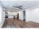 Open-concept living area with wood-look flooring, white walls, and a stainless steel kitchen at 3336 Forrest Hills Dr, Hapeville, GA 30354