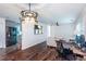 Open-concept living room featuring modern lighting, a comfortable sofa, and a connected workspace at 3336 Forrest Hills Dr, Hapeville, GA 30354