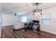 Bright living room with hardwood floors, modern light fixtures, and neutral decor at 3336 Forrest Hills Dr, Hapeville, GA 30354