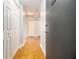 View of hallway with wooden floors, white doors and grey walls leading to the front door at 620 Peachtree Ne St # 1001, Atlanta, GA 30308