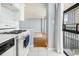 Kitchen view to the living area, balcony, white cabinets, and stainless steel appliances at 620 Peachtree Ne St # 1001, Atlanta, GA 30308