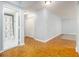 Open living area with wood-style flooring, large closet doors, bathroom, and light walls at 620 Peachtree Ne St # 1001, Atlanta, GA 30308