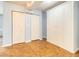 Neutral living area with wood-style flooring, closet doors and a large wardrobe at 620 Peachtree Ne St # 1001, Atlanta, GA 30308