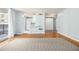 Open-concept living area featuring wood floors and a view to the kitchen with white appliances at 620 Peachtree Ne St # 1001, Atlanta, GA 30308