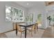 Well-lit dining room features hardwood floors, a large window, and a modern table set at 830 Gaston Sw St, Atlanta, GA 30310