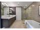 Elegant bathroom features a soaking tub, glass shower, and a double sink vanity with modern fixtures at 867 Peachtree Ne St # 702, Atlanta, GA 30308