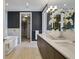 Well-appointed bathroom boasts a modern vanity, soaking tub, and access to a walk-in closet at 867 Peachtree Ne St # 702, Atlanta, GA 30308