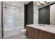 Modern bathroom featuring a stylish vanity, bathtub with glass enclosure, and contemporary fixtures at 867 Peachtree Ne St # 702, Atlanta, GA 30308