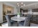 Dining area with contemporary table set and view into modern kitchen at 867 Peachtree Ne St # 702, Atlanta, GA 30308