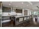 Modern kitchen with dark cabinets, island with barstool seating, and stainless steel appliances at 867 Peachtree Ne St # 702, Atlanta, GA 30308